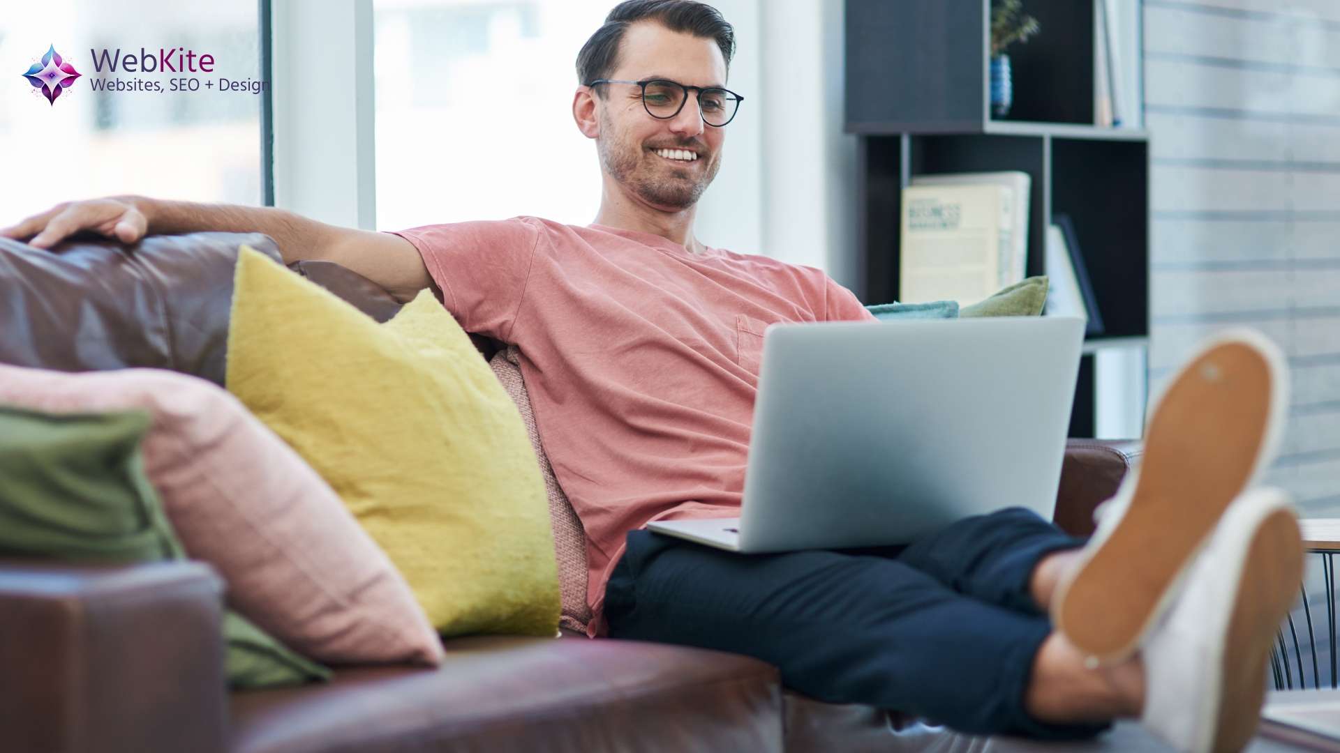 A smiling executive at his laptop