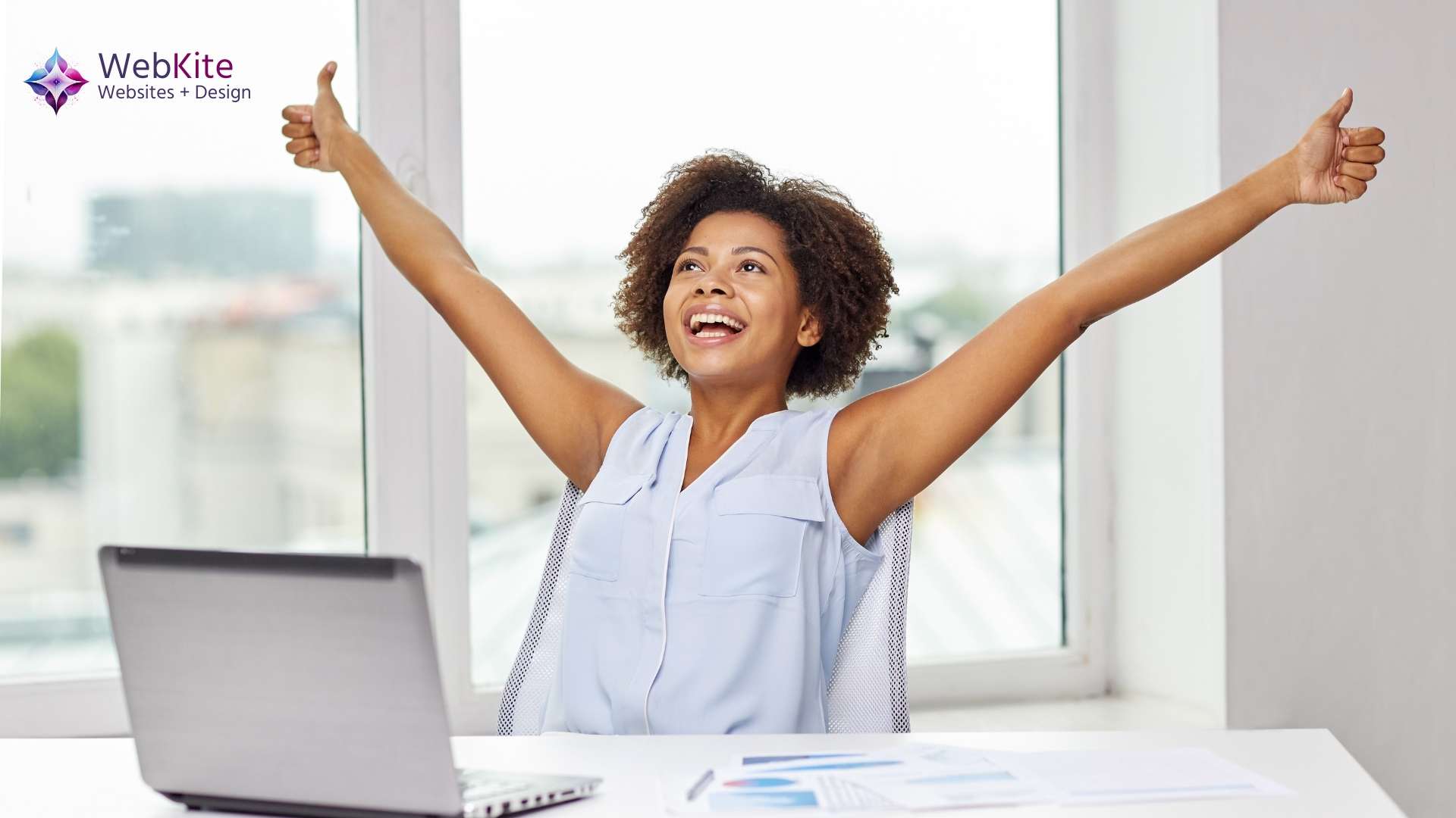 An excited excutive woman at her laptop