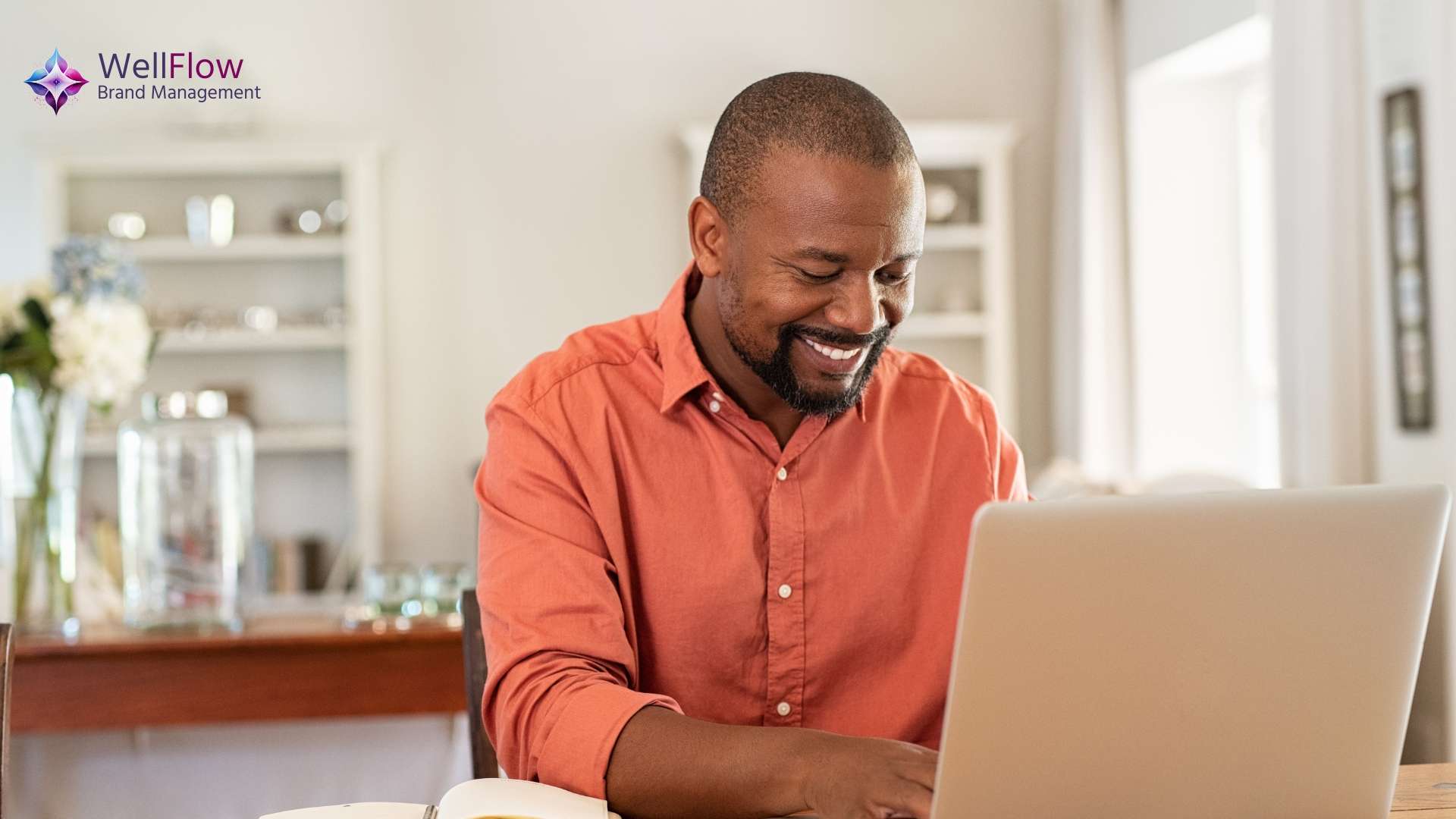 An executive smiling at his laptop